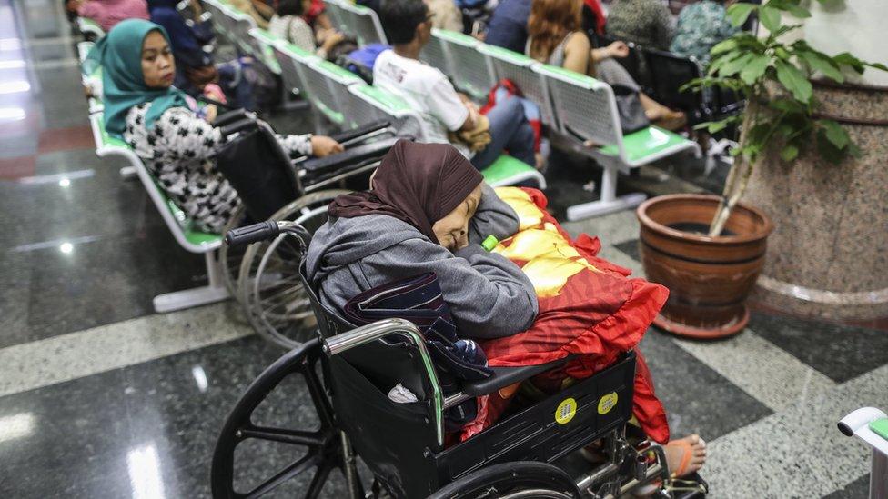 People waiting in busy hospital