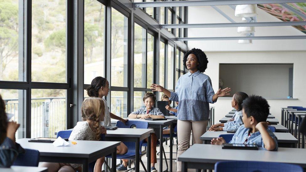 Teacher teaching a small class of children