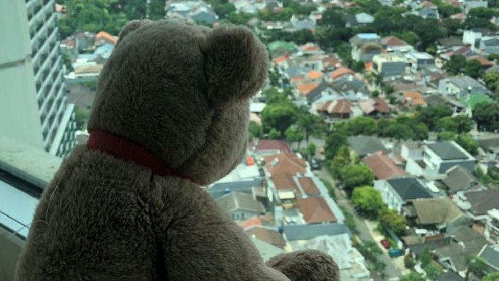 A teddy bear on a windowsill in Jakarta, Indonesia