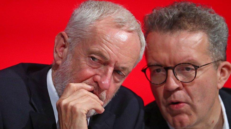 Jeremy Corbyn and Tom Watson sit together on stage at the annual Labour Party Conference in Liverpool