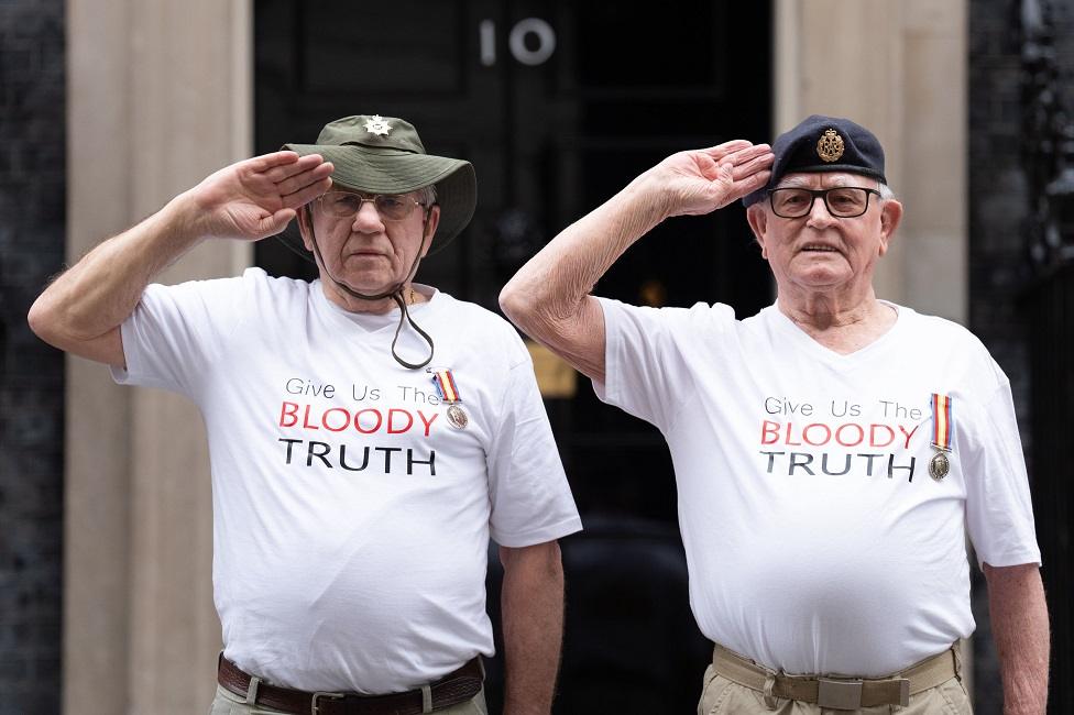 Veterans Terry Quinlan and Brian Unthank salute in front of 10 Downing Street