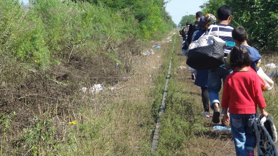 Afghan asylum seekers walking down train tracks 24 August 2015