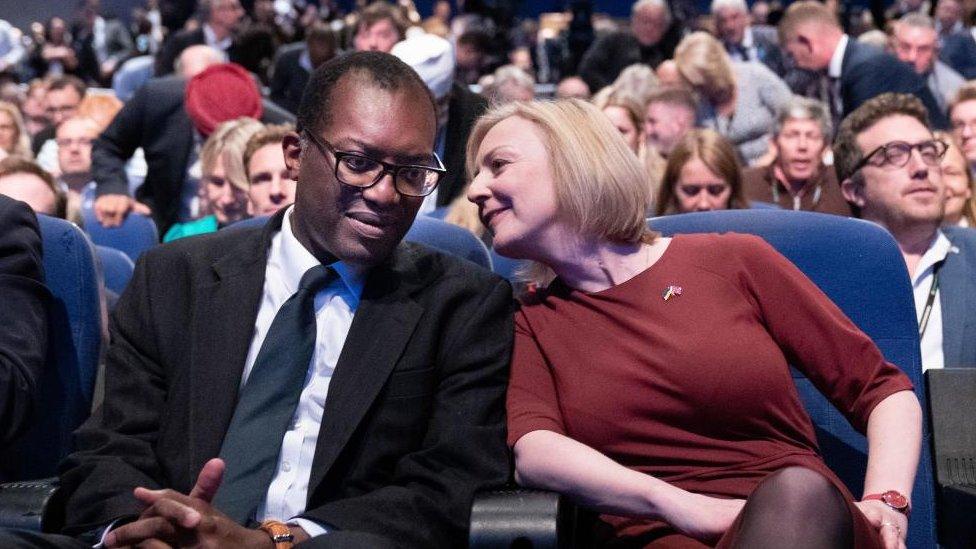 Liz Truss leans over to speak to Kwasi Kwarteng at the Conservative part conference in 2022