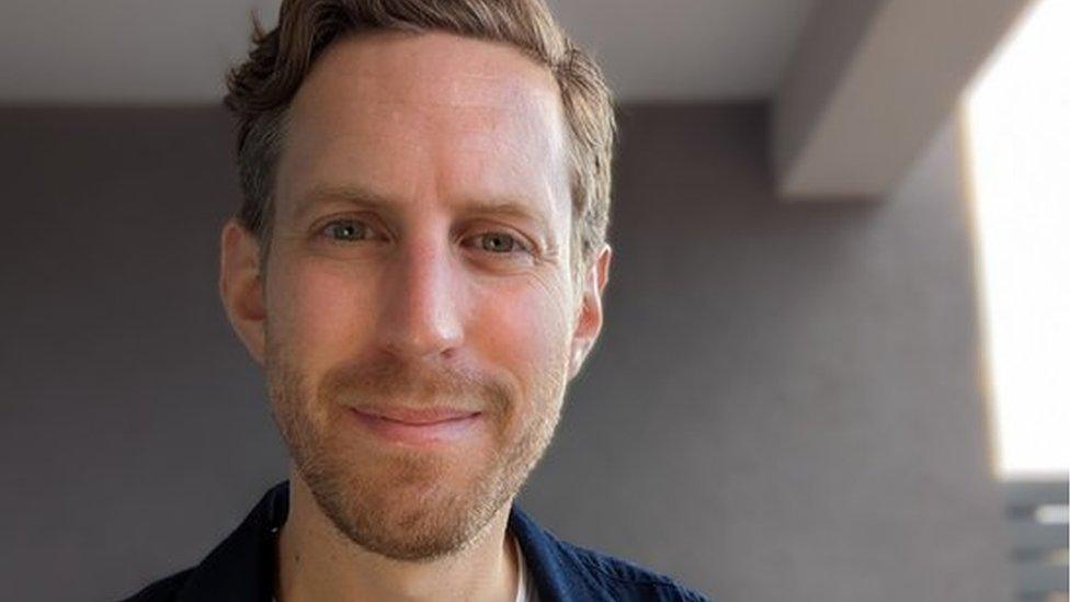 Matt Lloyd-Rose, a man with light hair and a beard, in a navy jacket and white shirt.