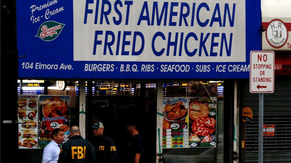 FBI officers enter a restaurant called "First American Fried Chicken"