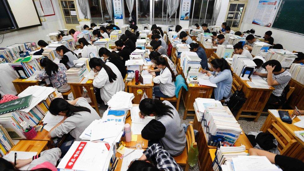 This photo taken on May 24, 2016 shows senior high school students studying at night to prepare for the college entrance exams at a high school