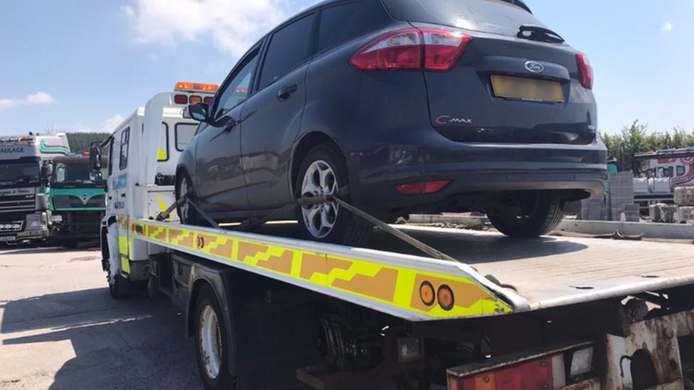 Rhiannon Jones's broken down Ford C-Max on the back of a recovery vehicle