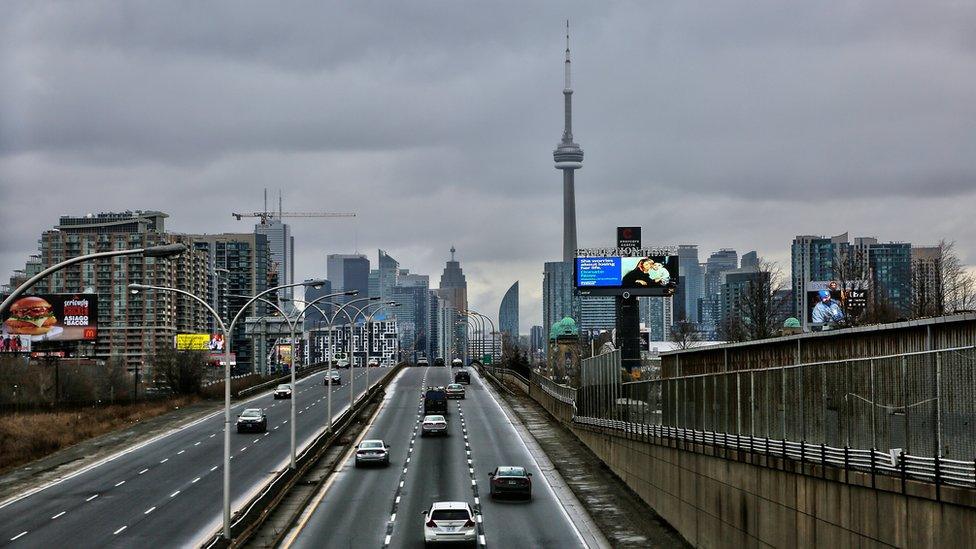 Traffic seen with the skyline of downtown Toronto, Ontario, Canada