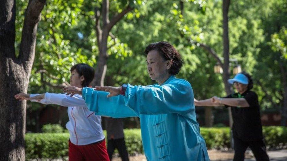 Chinese ladies practise tai chi in parks.