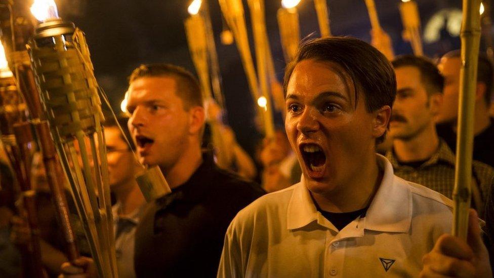 Peter Cvjetanovic seen yelling and holding a torch after marching through the University of Virginia campus