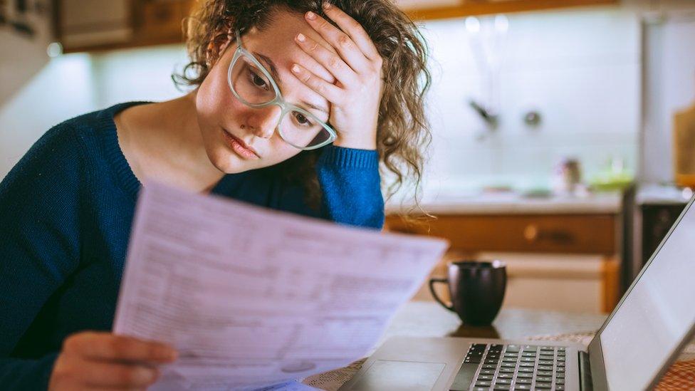 woman looking at bills