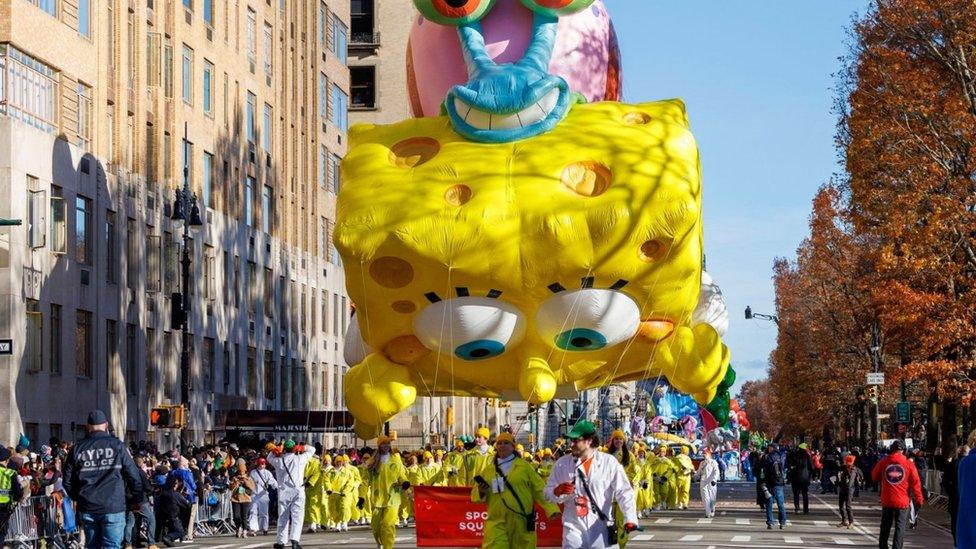 A balloon depicting SpongeBob SquarePants floats through New York City