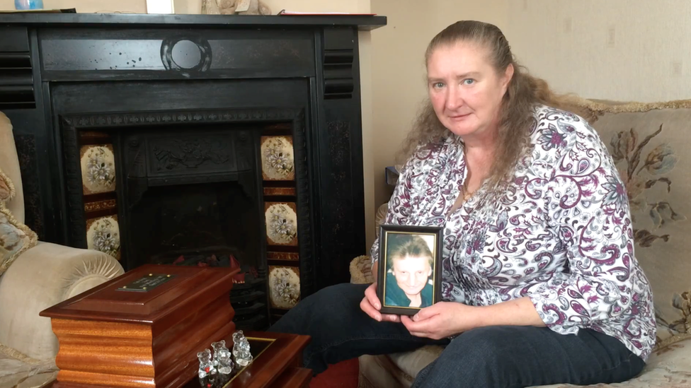 Mandy Stock with a picture of her husband