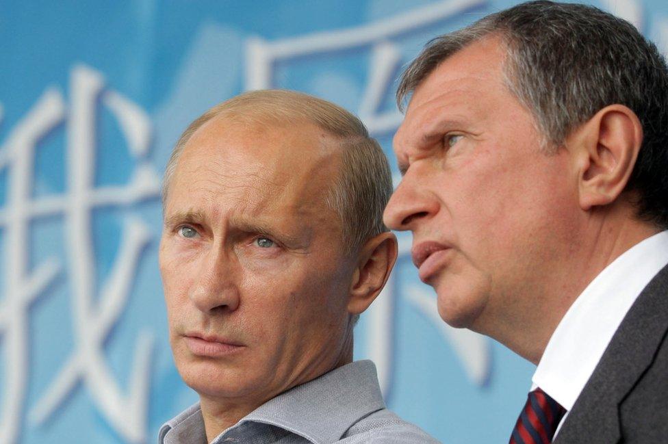 President Putin (L) counts Rosneft oil boss Igor Sechin (R) - 2010 file pic