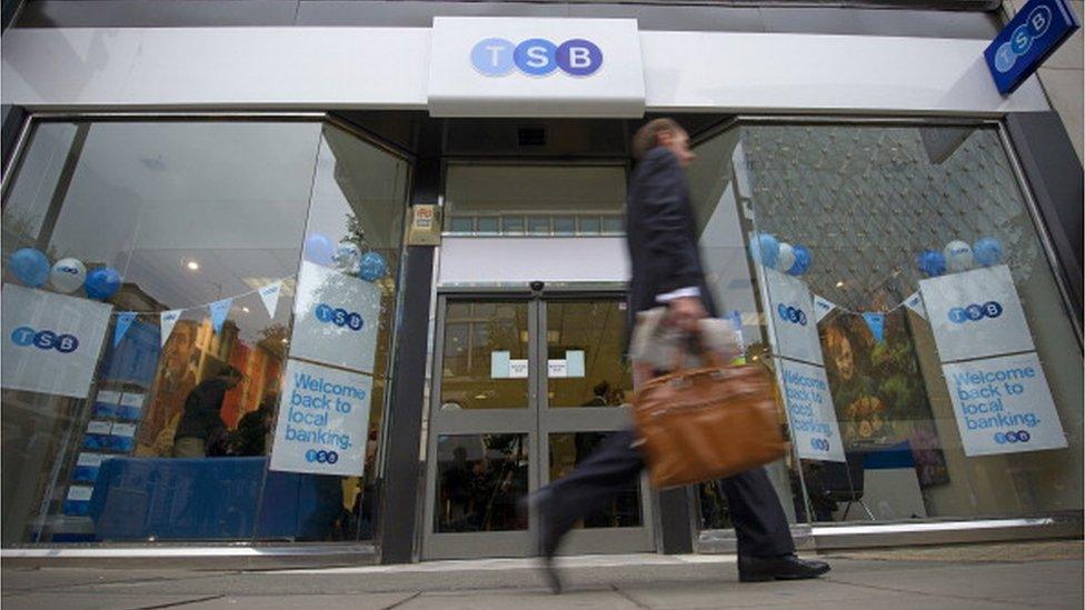 Man walking past TSB bank