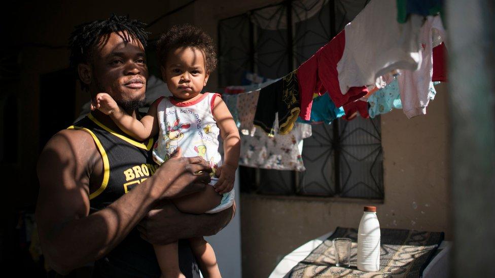 Popole Misenga holds his one-year-old son Elias at their home in Rio de Janeiro, Brazil - Friday 27 May 2016