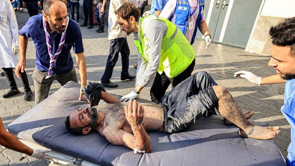 Paramedics transport an injured man to al-Shifa hospital in Gaza City