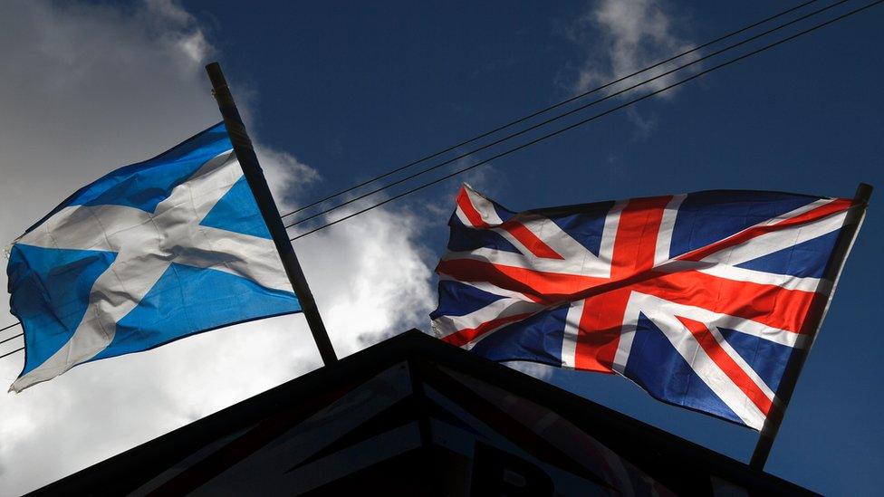 A saltire flag and Union Jack flutter in the wind on March 9, 2017 i