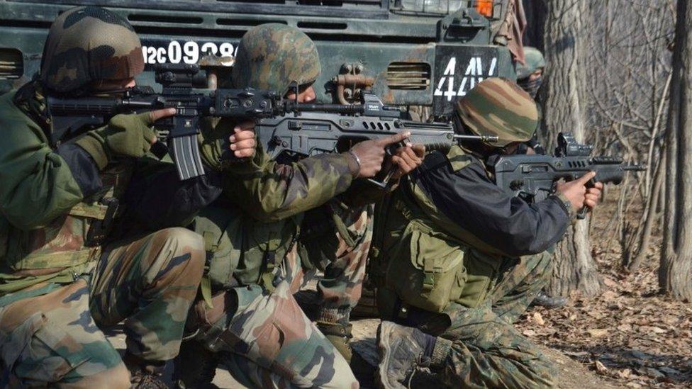 Indian army soldiers take position near the site of gunfight (12 February 2017)