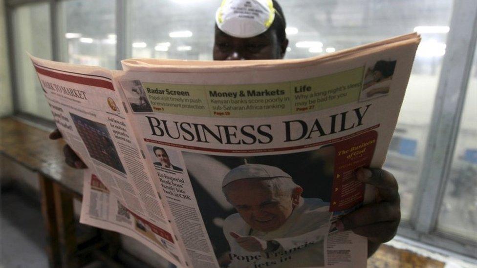 A supervisor checks the quality of a copy of the Business Daily newspaper, with an image of Pope Francis on its front page, produced by the Nation Media Group at a printing press plant on the outskirts of Kenya"s capital Nairobi, November 24, 2015