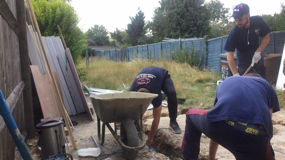 Builders working to renovate a house