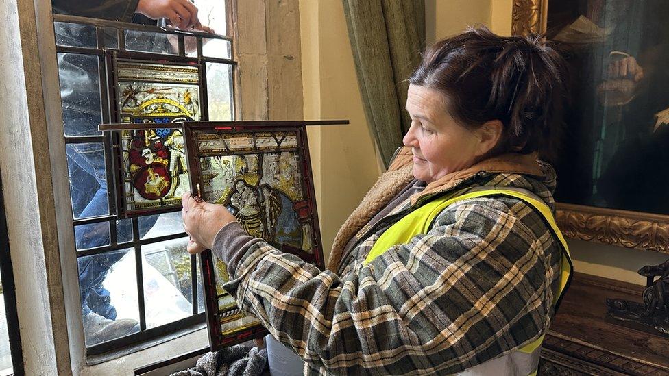 woman holding stained glass window pane