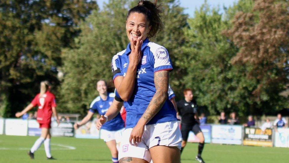 Natasha Thomas celebrating scoring a hat-trick, against Cheltenham by holding up three fingers at the AGL Arena in Felixstowe.