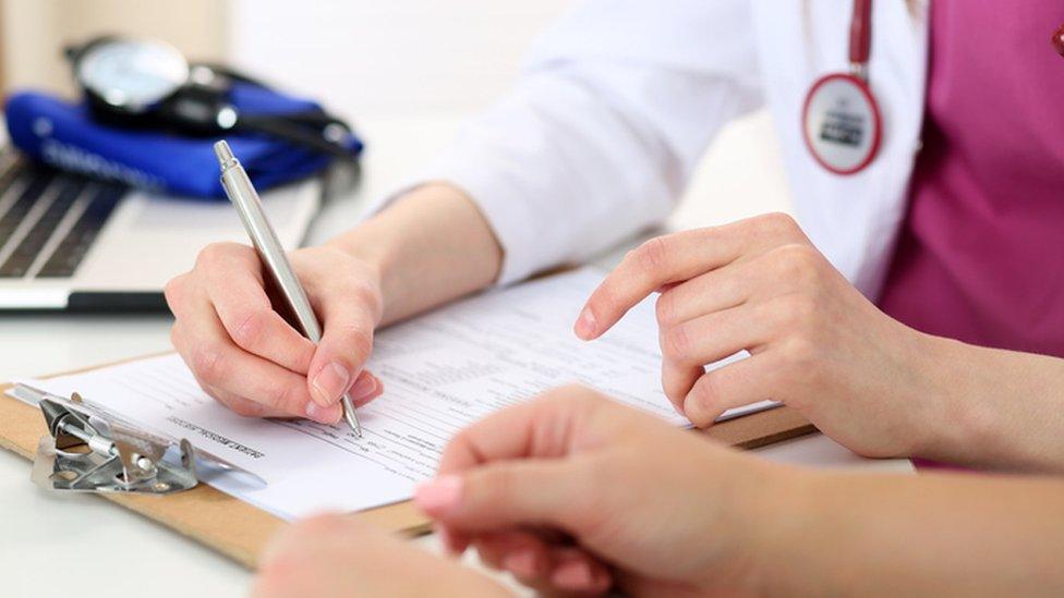 Doctor writing notes, stock image