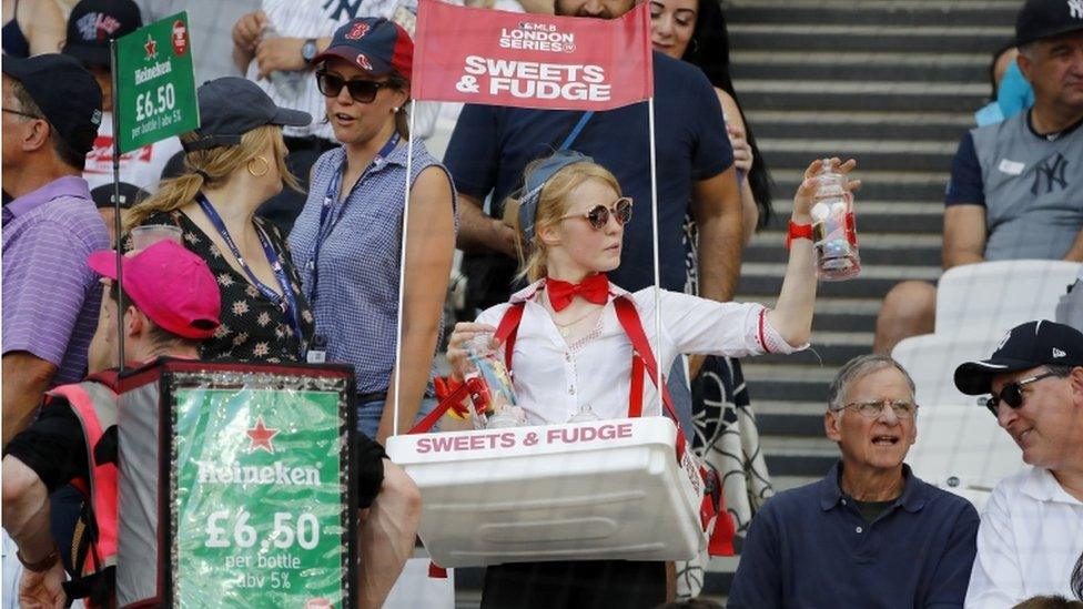 A vendor sells sweets during the first of a two-game series between the New York Yankees and the Boston Red Sox