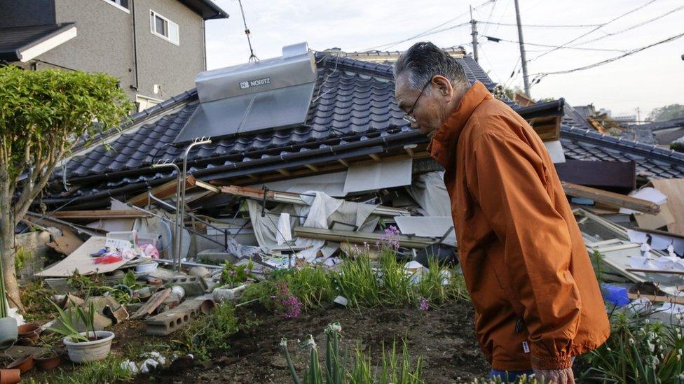 A resident outside his house collapsed in Mashiki, Kumamoto Prefecture, south-western Japan (16 April 2016)