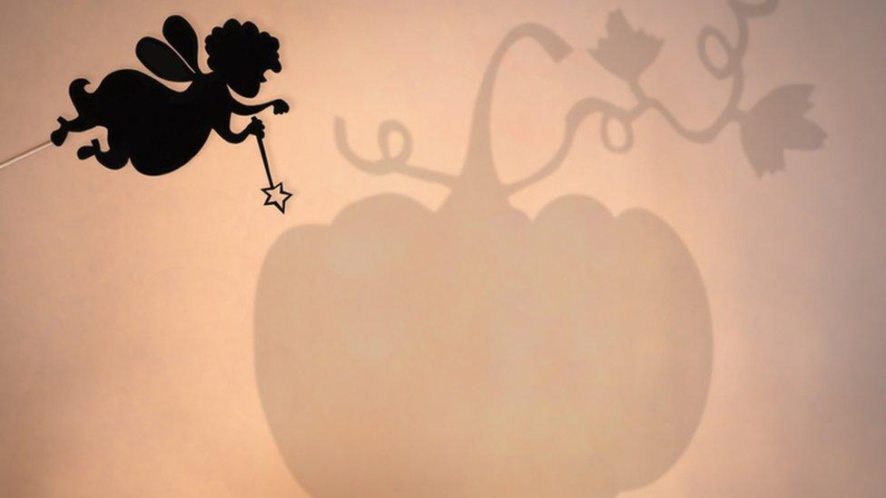 Silhouette of a fairy godmother with a fairy