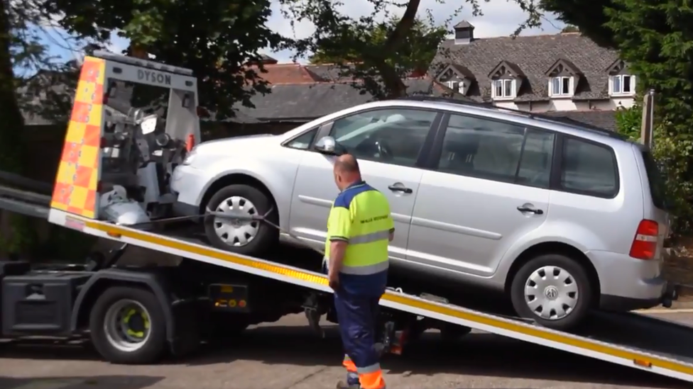 A car being towed by police