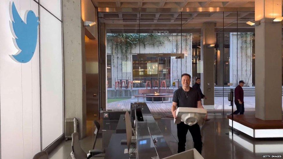 Elon Musk holding a sink in Twitter HQ