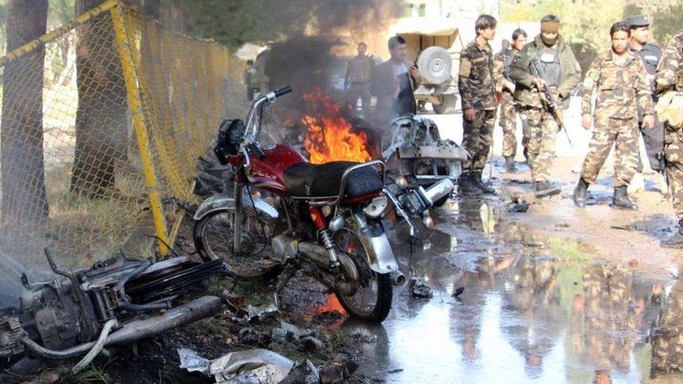 Afghan security officials at the scene of a suicide bomb attack in Lashkar Gah, Helmand province (11 February 2017)