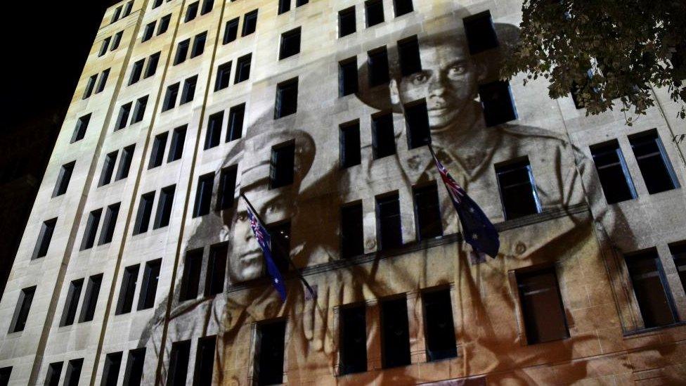 World War I images are projected on a building at the Cenotaph during the Anzac Day dawn service in Sydney (25 April 2018)