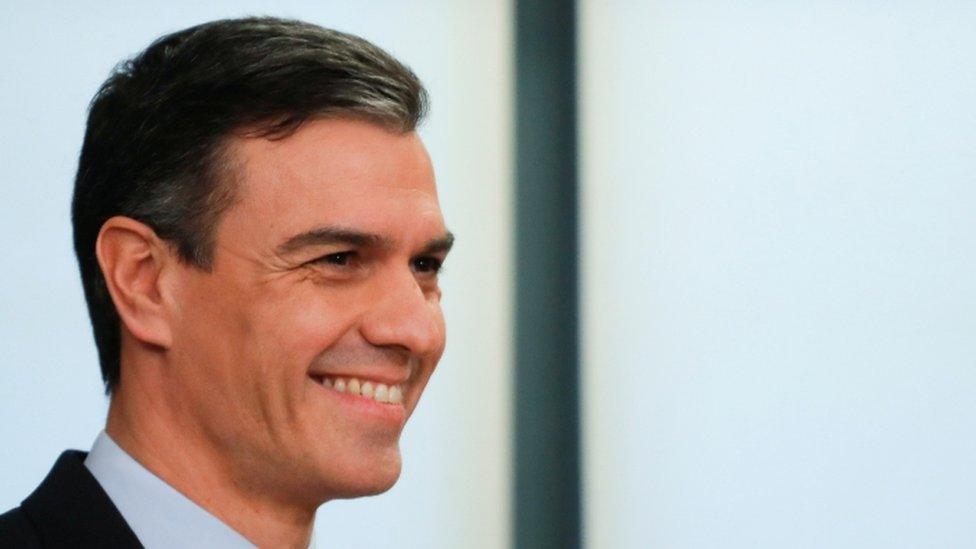 Spain's acting Prime Minister Pedro Sanchez smiles during a presentation of a coalition agreement with Podemos