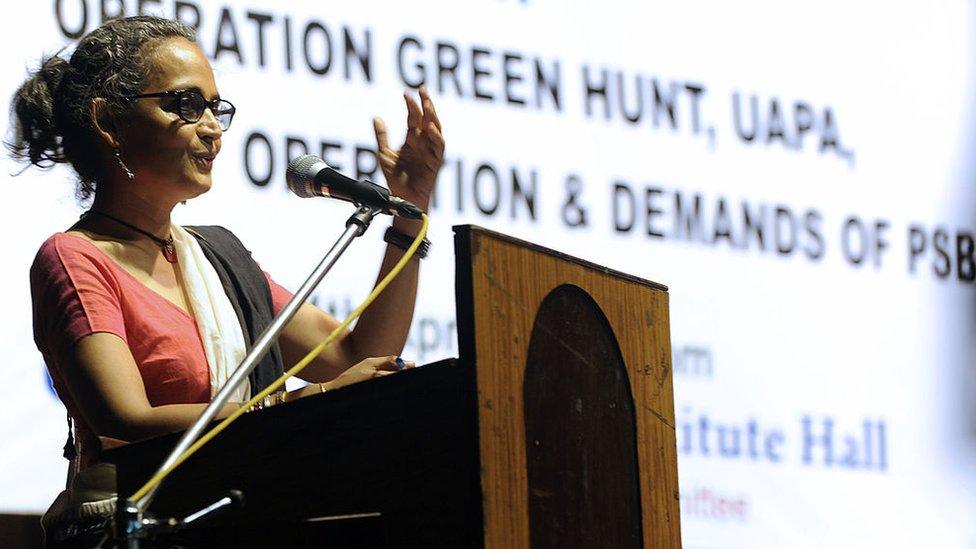 Indian writer and activist Arundhati Roy gestures as she addresses a gathering of intellectuals and students in Kolkata on April 14, 2010.