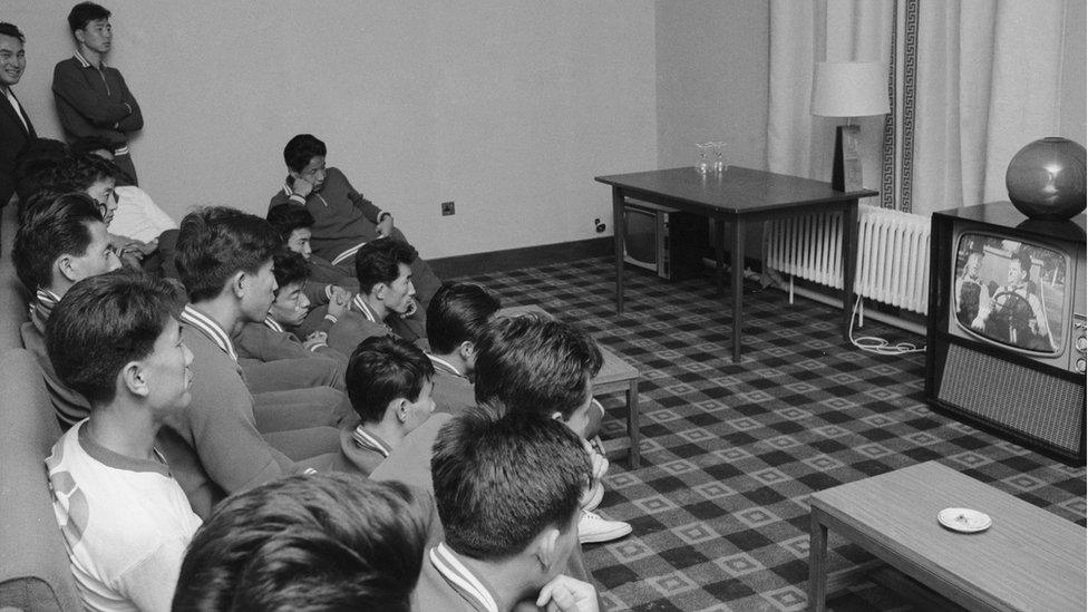 Members of the North Korean World Cup squad watching Towed In A Hole, a Laurel & Hardy comedy, on TV in their hotel. The team is in Middlesbrough before the first match of the tournament, in which they play the Soviet Union at Ayresome Park on 12 July 1966.