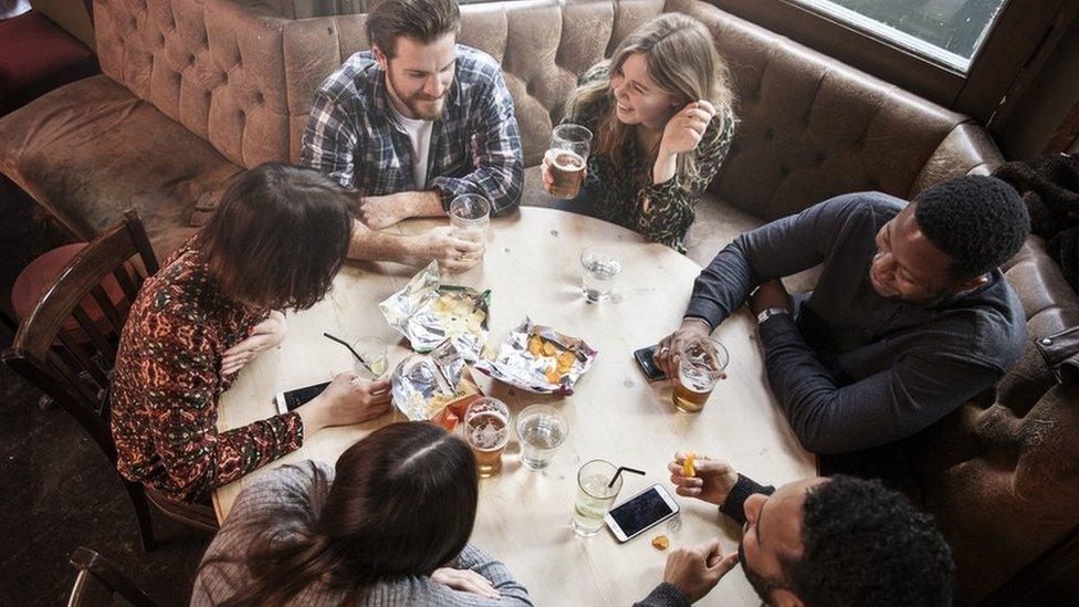 Six people drinking in a pub