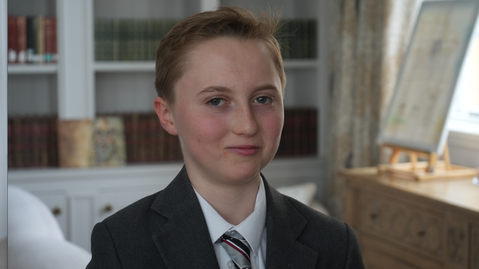 School pupil Olivia, sitting in school library