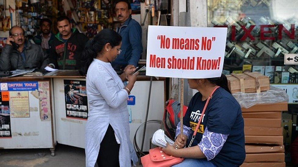 A Woman holds a placard during a protest against rape and violence against women in New Delhi on March 6, 2019