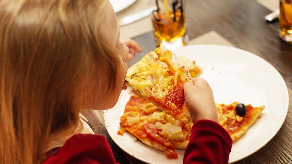 Girl eating pizza