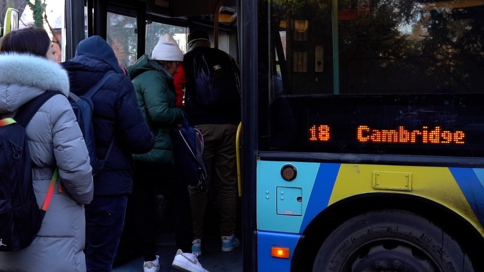 Passengers boarding a number 18 bus