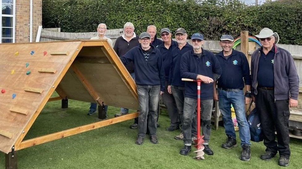 Men's Shed group stand by climbing frame