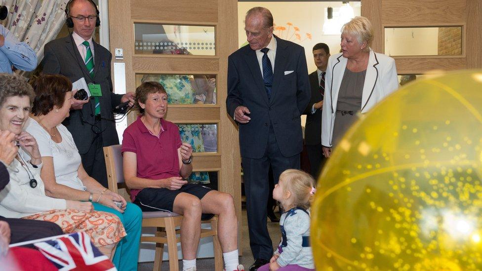 Prince Philip watches residents as they exercise in the Green Lane View assisted-living residential home during an official visit to the St Michael's Care Complex in Aylsham on October 8, 2013