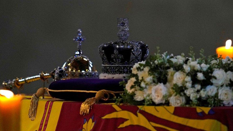 The Imperial State Crown and the Sovereign's orb and sceptre on top of the Queen's coffin.