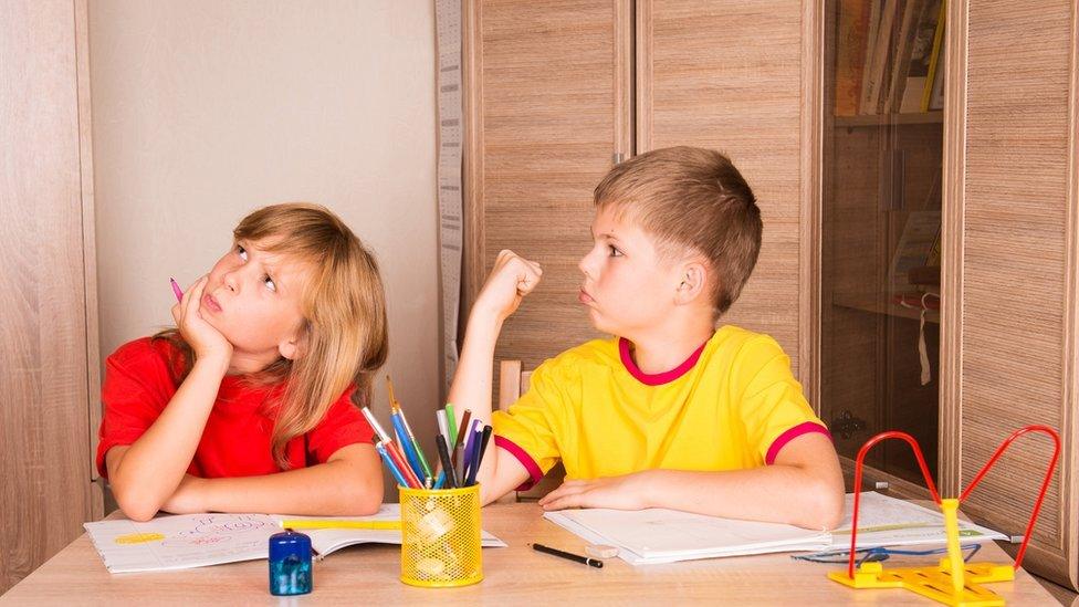 Children quarrelling over homework