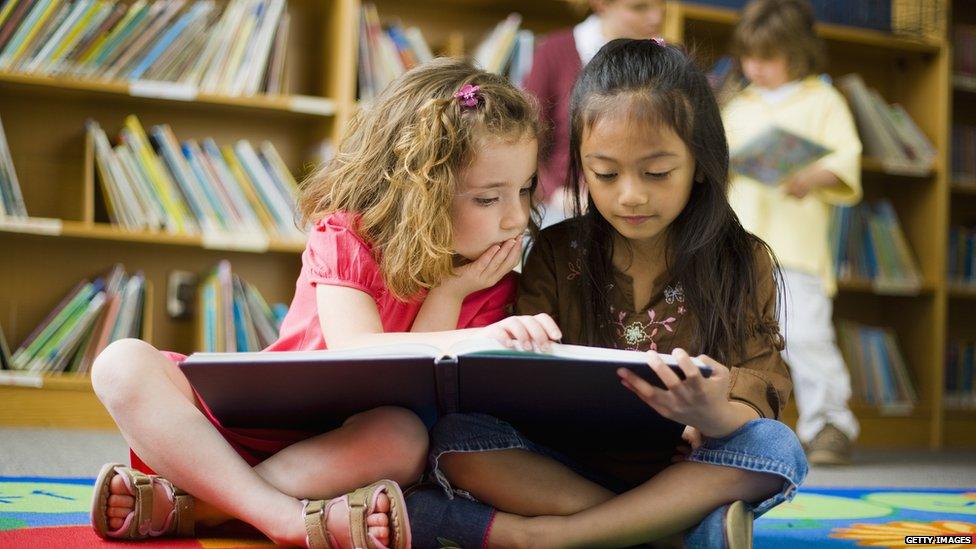 A photo of two girls reading