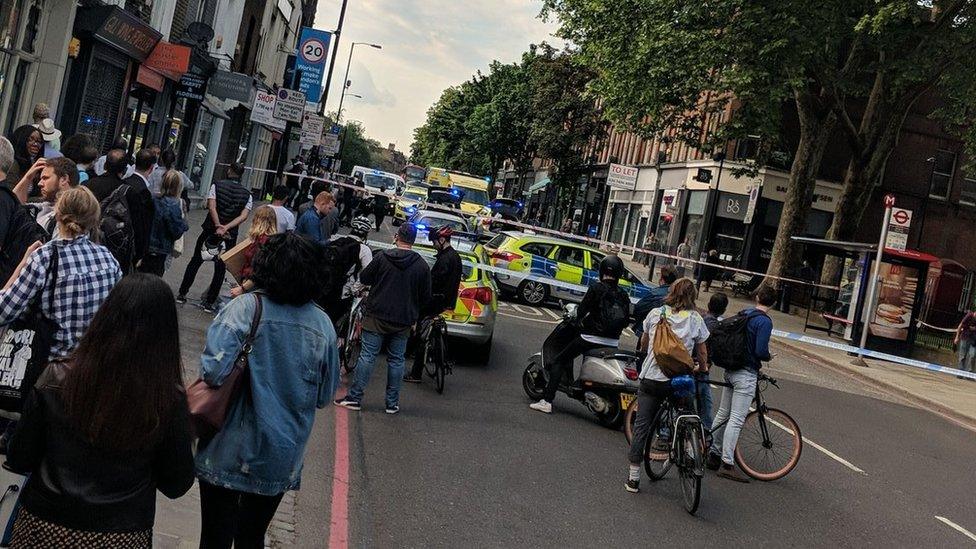 the scene close to where a man has been stabbed to death on a busy street