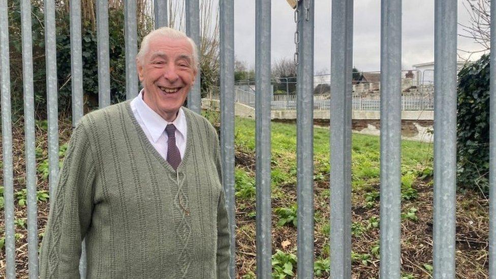 Michael Read, in front of Broomhill Lido, wearing a green cardigan and a tie